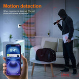 Person receiving motion alerts on smartphone for hidden camera in a home setting.