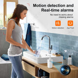 Woman using motion detection security camera in a modern bathroom, showcasing real-time alarm features.
