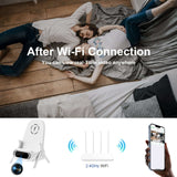 Couple relaxing at home with WiFi hidden camera charging stand and smartphone displaying video feed.